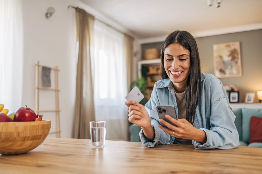 Woman making a secure payment by phone with a credit card